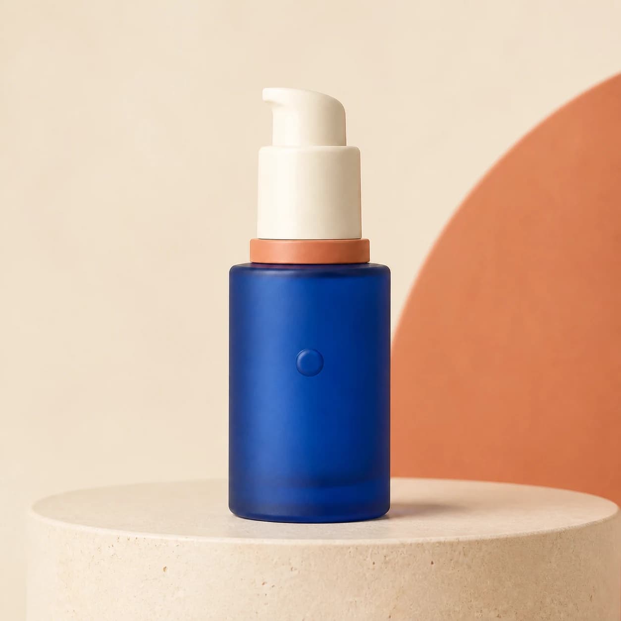 Fictional cobalt-blue serum bottle in a premium studio product photograph with sculptural neutral props